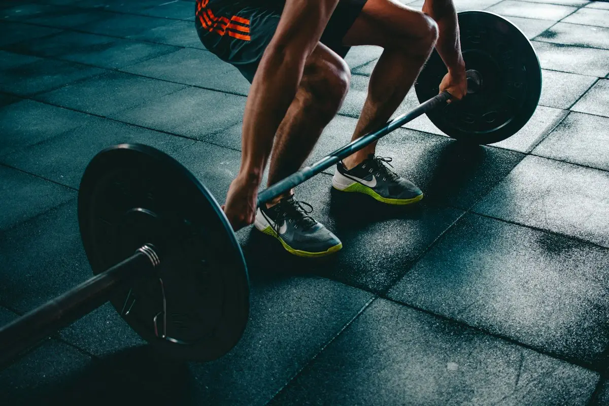An athlete gripping a loaded barbell