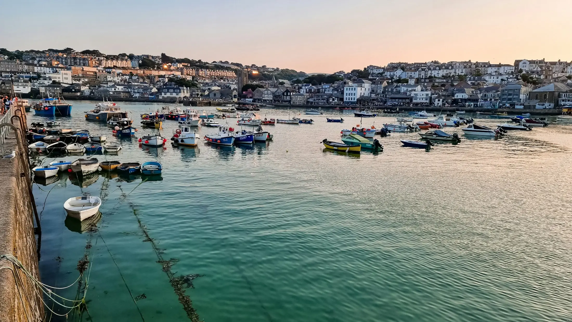 St Ives harbour at first light, small boats moored below the town