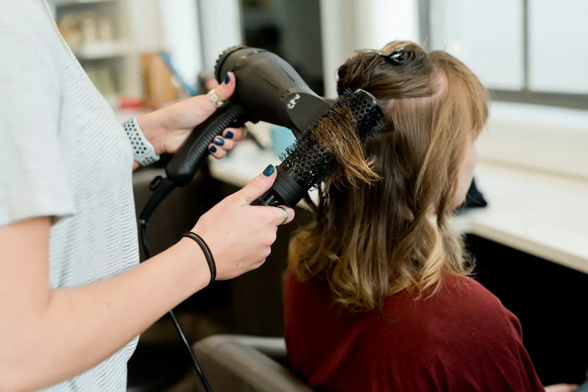 A stylist finishing a blow dry